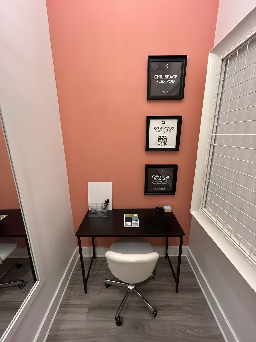 The Podcast Booth set with a microphone and laptop
